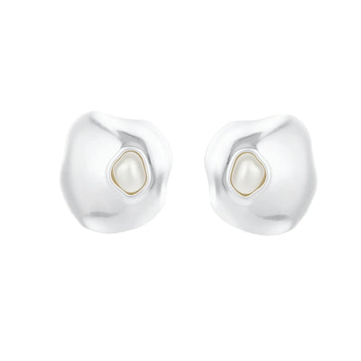 Organic-shaped eco-zinc alloy stud earrings with resin pearl centers and sterling silver posts on white background.