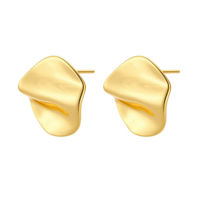 Close-up of organic gold-plated sterling silver stud earrings with flowing sculptural design and curved cut-outs
