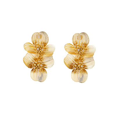 Pair of gold-plated double flower earrings with textured petals and crystal centers on cream background.