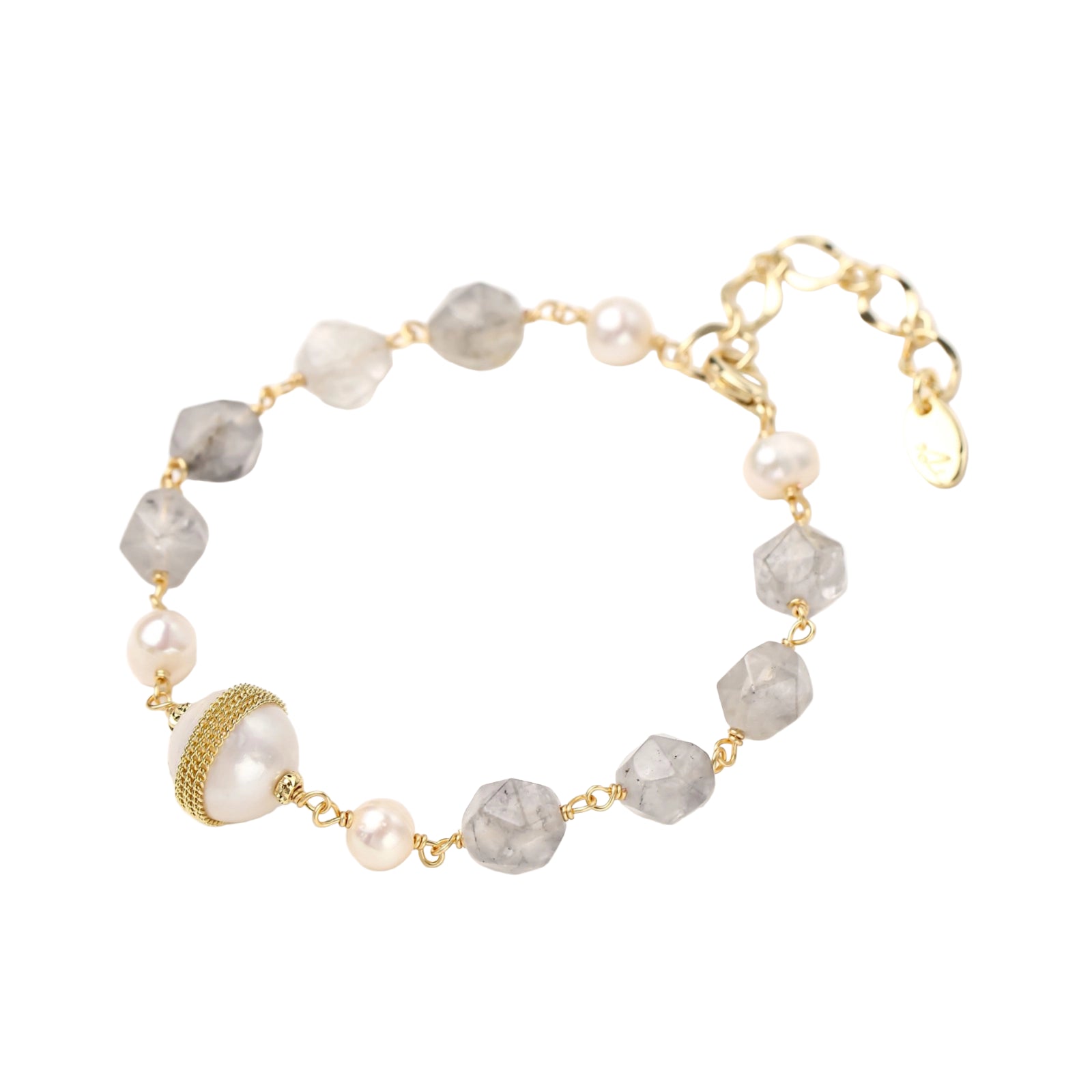 Bracelet with cloudy quartz beads, freshwater pearls, and gold-wrapped baroque pearl centerpiece on white background.
